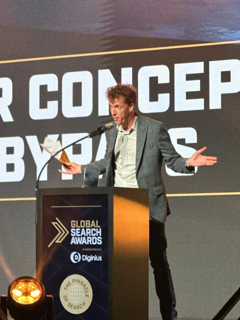 Owain Lloyd-Williams presenting on stage at search awards