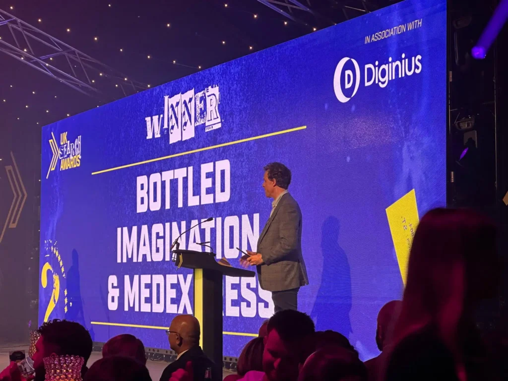 Owain Lloyd-Williams presenting on stage at search awards