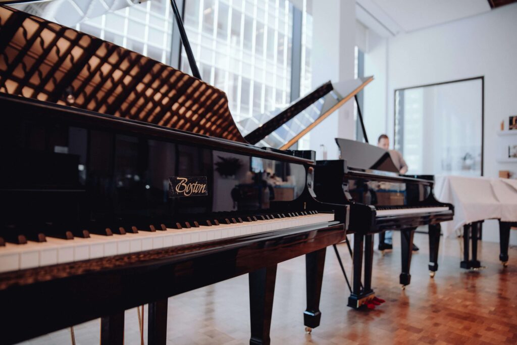 two grand pianos lined up in a studio